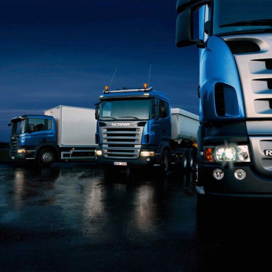 Three-trucks-on-blue-background-540x540.jpg